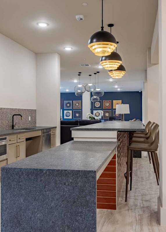 Community kitchen with blue granite island seating at Emilia, Boerne, TX, 78006