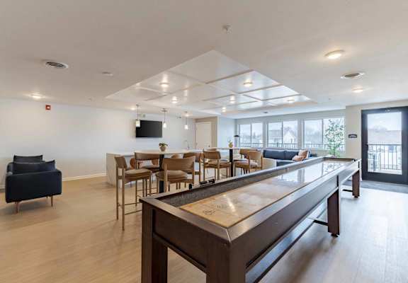 A modern living room with a long wooden table and chairs.