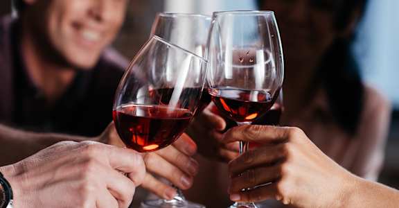 people toasting with wine glasses in a restaurant