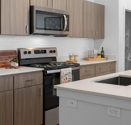 A kitchen with a white countertop and brown cabinets.