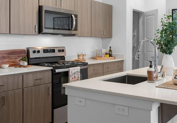 A kitchen with a white countertop and brown cabinets.