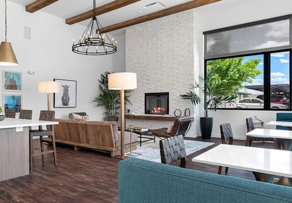 A modern living room with a kitchen area in the background.