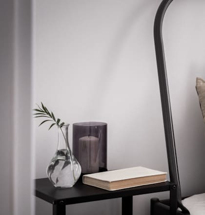 A bed with white pillows and a black metal frame.at 21 West, New York New York