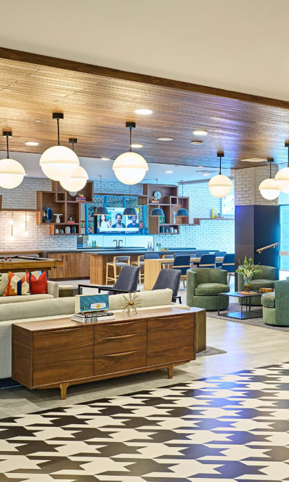 a lobby of a hotel with couches and chairs and a fireplace at Dey & Bergen, Harrison, 07029