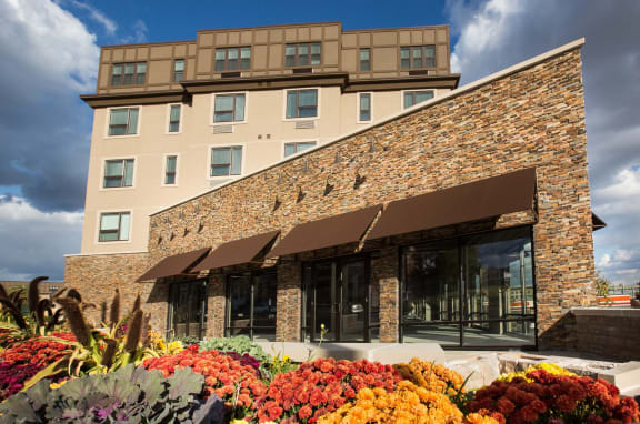 Exterior view of building with flowers surrounding entrance