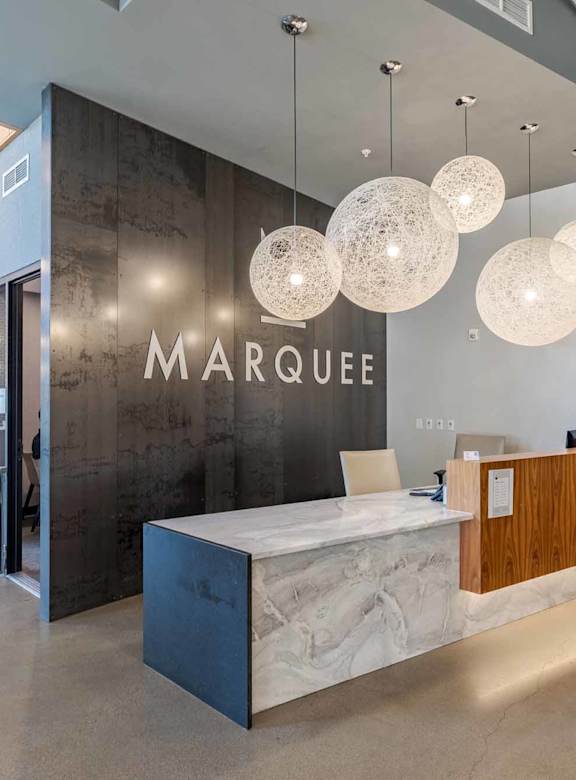 a living room with chairs and a table at Marquee, Minnesota