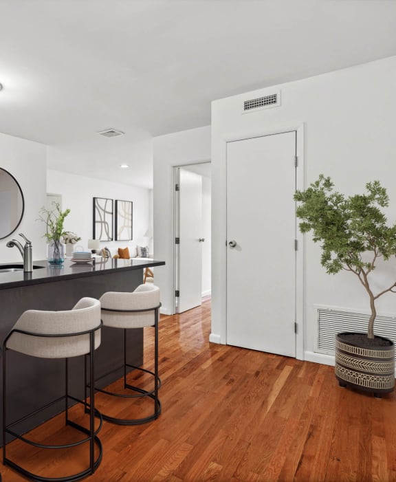 a kitchen with white walls and a black countertop