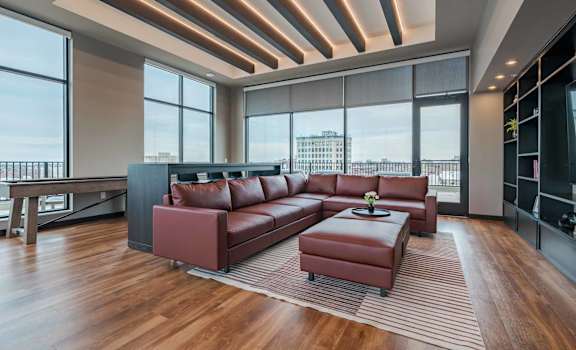 A modern living room with a large red sofa and a coffee table.