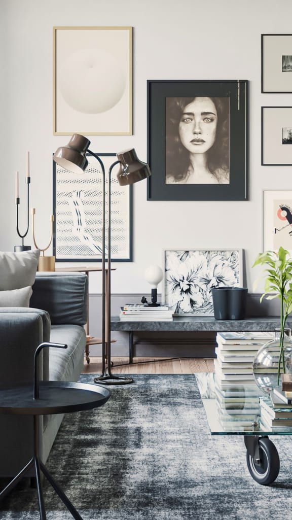 a dark grey living room with a glass coffee table