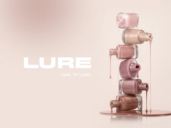A stack of nail polish bottles with the brand name LURE Nail Studio.