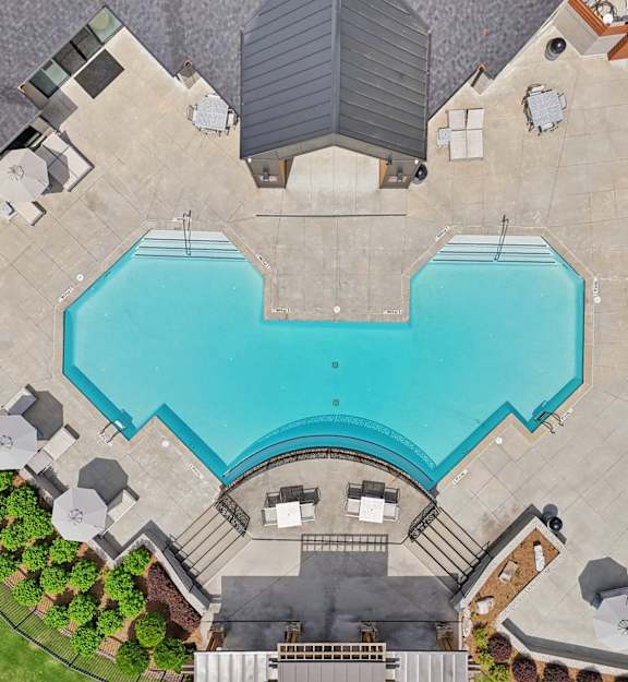 an aerial view of a resort pool and spa at night