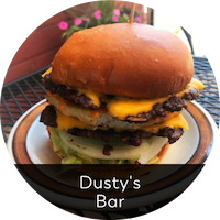 a double cheeseburger on a plate on a table