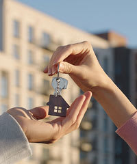 A person is handing over a key to another person.