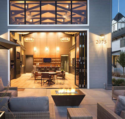 A modern house with a patio and outdoor furniture.