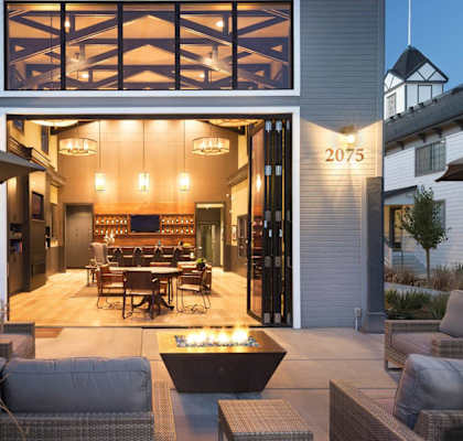 A modern house with a patio and outdoor furniture.