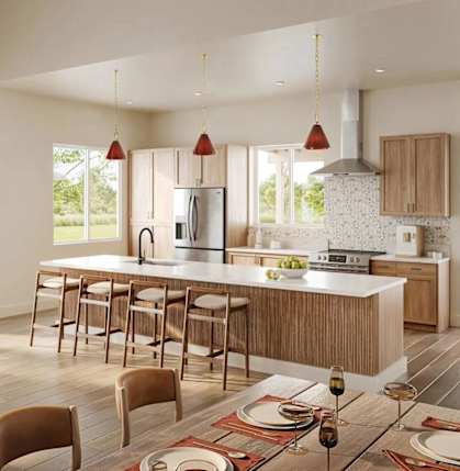 A modern kitchen with a dining table set for two.