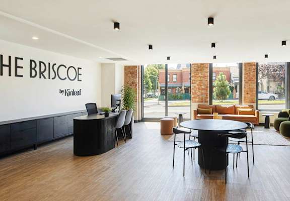 the building has a large lobby with a table and chairs