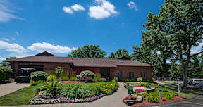 A building with a landscaped garden in front.