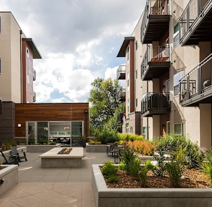 a courtyard with a fire pit in the middle of an apartment building