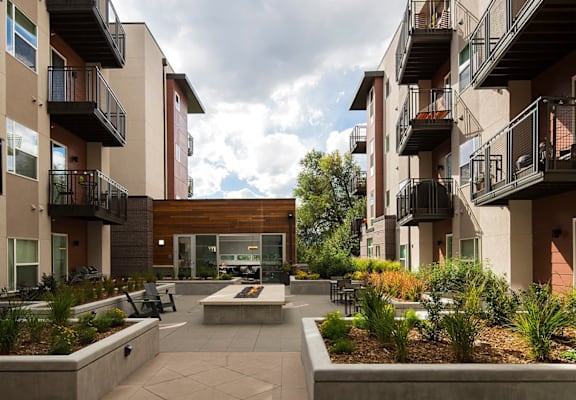 a courtyard with a fire pit in the middle of an apartment building
