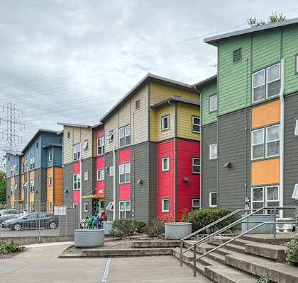 A colorful apartment complex with a bicycle parked in front.