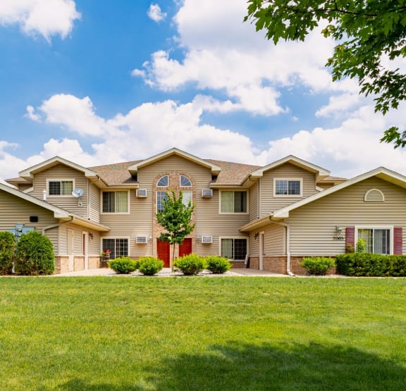 a house with a green lawn in front of it