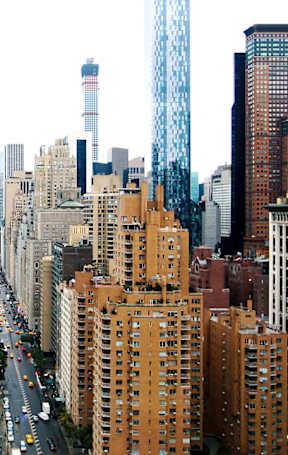 A cityscape with a mix of greenery and buildings. at The Ellington Apartments, New York, NY, 10019
