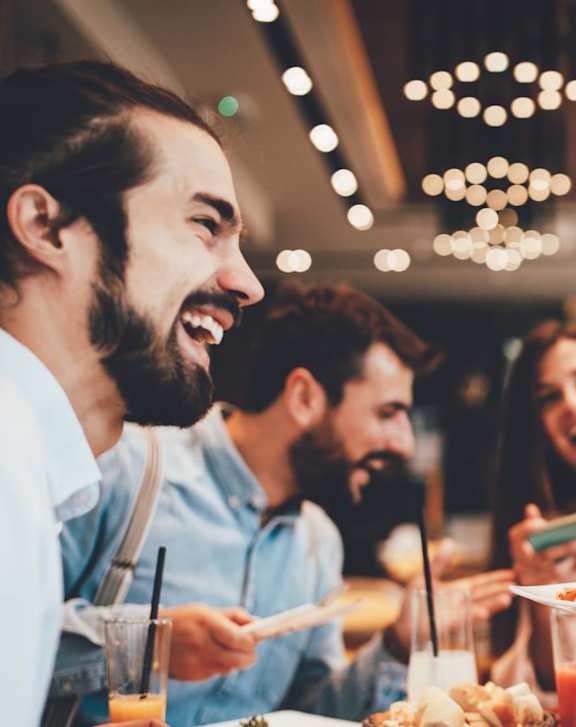 A group of people enjoying a meal together in a restaurant.