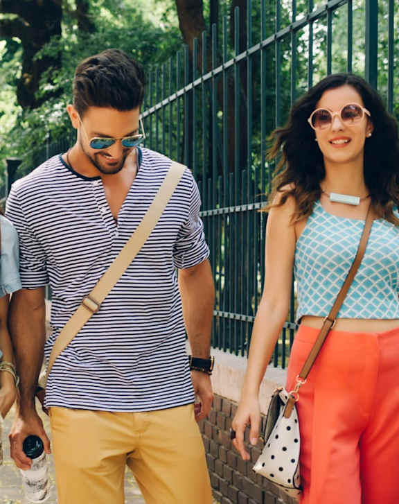 Four friends walking down a street.