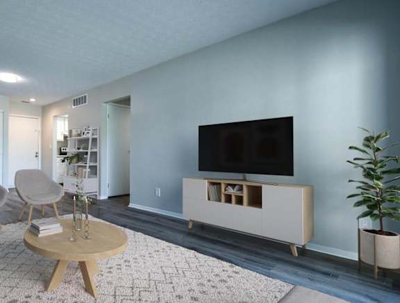 a living room with blue walls and a flat screen tv on the wall