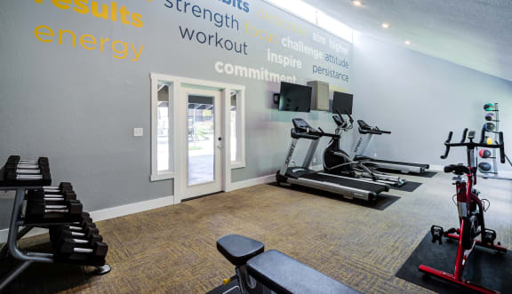 a gym with treadmills and other exercise equipment  at The Clubhouse at Port Orchard, Washington