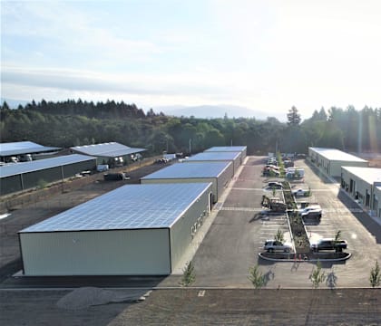 an aerial view of a hangar with several buildings and airplanes