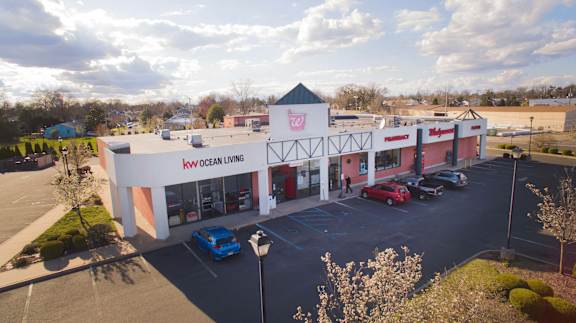 an aerial view of a store with cars parked in front of it