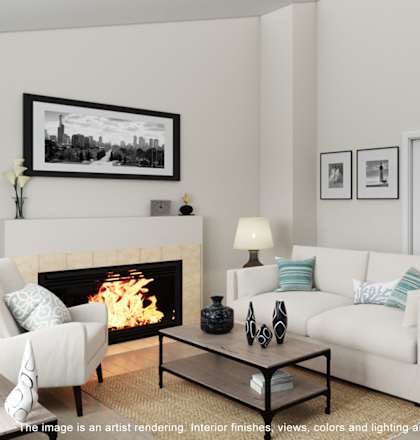 A living room with a fireplace, a couch, a chair, a coffee table, and pictures on the wall.