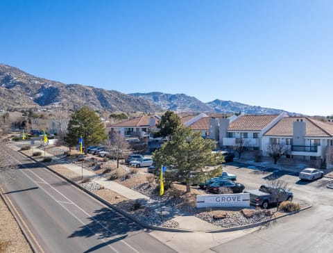 an aerial view of an apartment complex with mountains in the background
