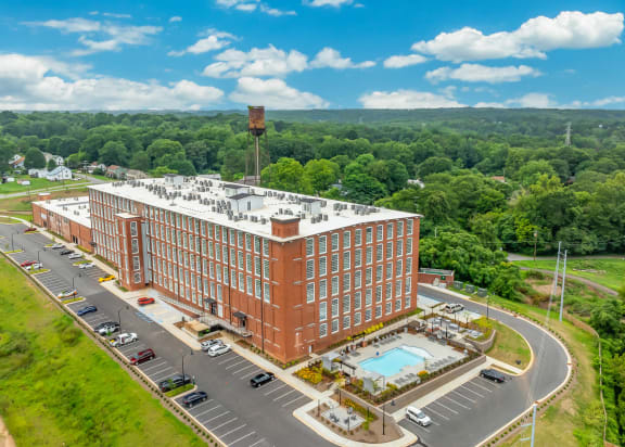Aerial view of Converse Mill Lofts surrounded by lush greenery.
