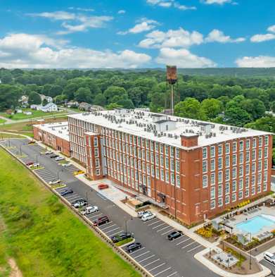 an aerial view of a building and a parking lot