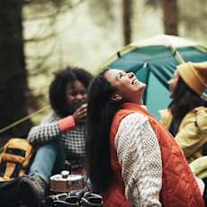 Three Friends Enjoying a Day Camping in the Woods with a Blue Tent at Country Woods, Ogden, UT 84401