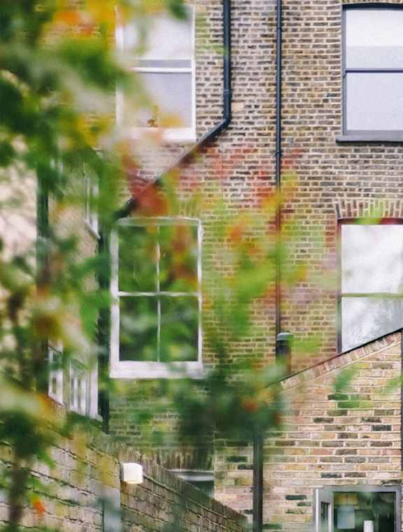 a view of a brick building with a staircase next to it