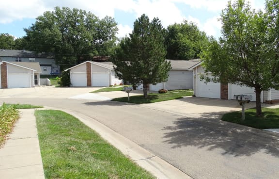 a street of houses in a neighborhood with trees