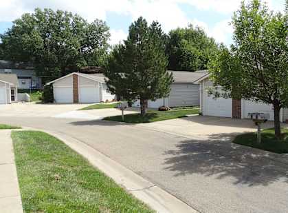 a street of houses in a neighborhood with trees