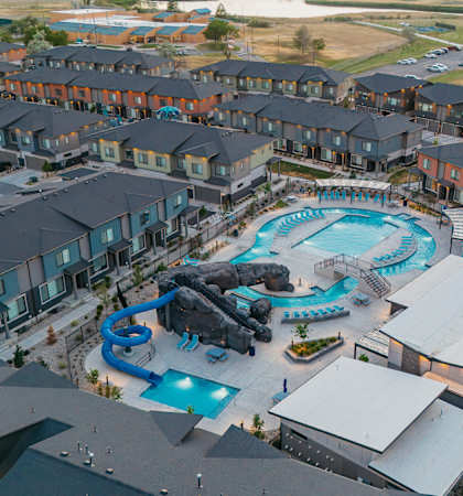 A large swimming pool surrounded by apartment buildings.