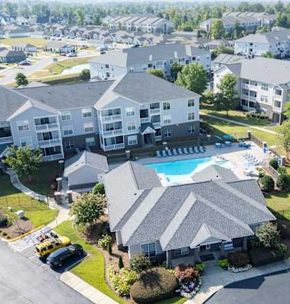 an aerial view of a neighborhood with a swimming pool and houses