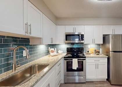 A kitchen with a stainless steel refrigerator, stove, and oven. at Vinings RiverVue, Atlanta, GA