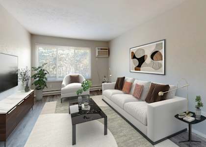 A living room with a white couch, a television, and a coffee table.