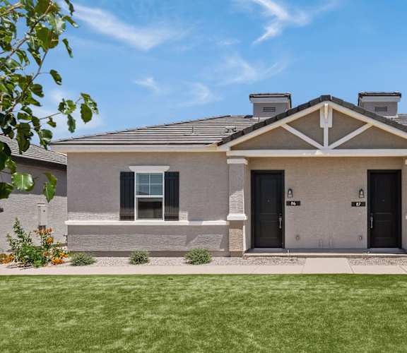 the front of a brick house with a green lawn at Zora Encanto, Arizona 85035