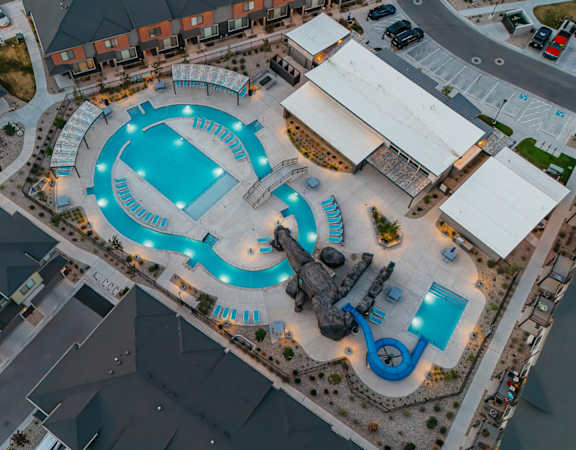 An aerial view of a water park with a large pool and water slides.