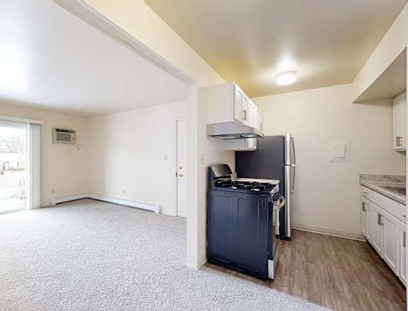 A kitchen area with a refrigerator, oven, and microwave.