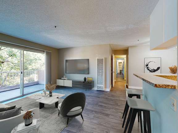 A modern living room with a large window and a flat screen TV.
