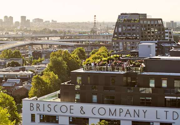 A building with the sign "Briscoe & Company Ltd" is shown with a cityscape in the background.